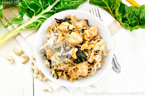 Image of Funchoza with chard and meat in bowl on light board top