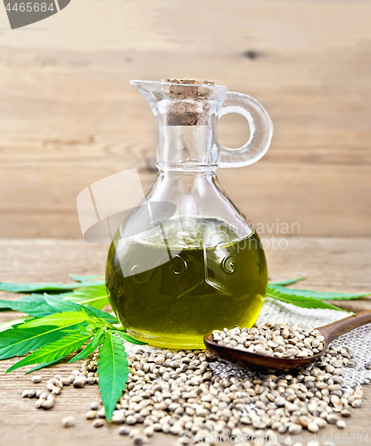 Image of Oil hemp in glass decanter on board