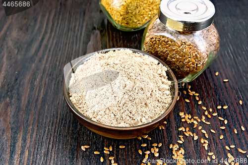 Image of Flour linen in bowl with seeds in glass jars on dark board