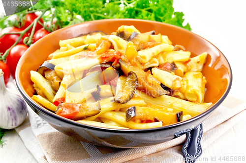 Image of Pasta penne with eggplant and tomatoes on table