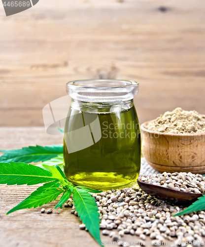 Image of Oil hemp in jar with flour in bowl on board