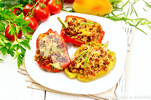 Image of Pepper stuffed with meat and couscous in plate on light board