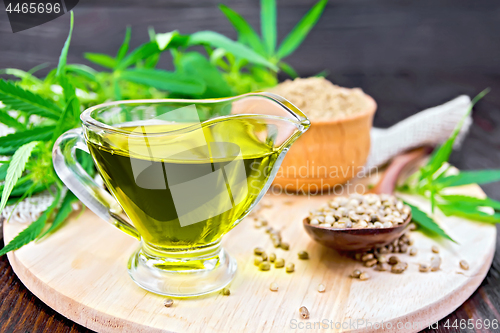 Image of Oil hemp in sauceboat with grain on board