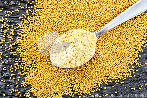 Image of Mustard powder in spoon on board top