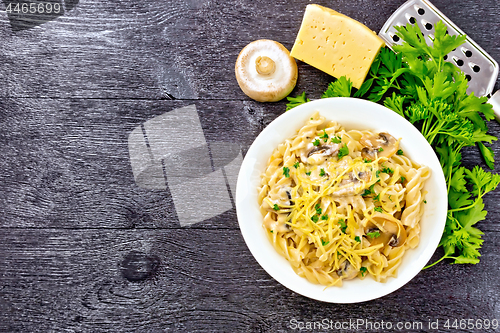 Image of Fusilli with mushrooms in plate on board top