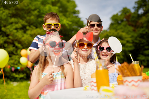 Image of happy kids with party props on birthday in summer