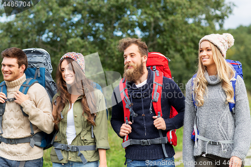 Image of friends or travelers with backpacks hiking