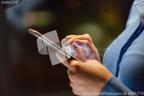 Image of close up of businesswoman hands with smartphone