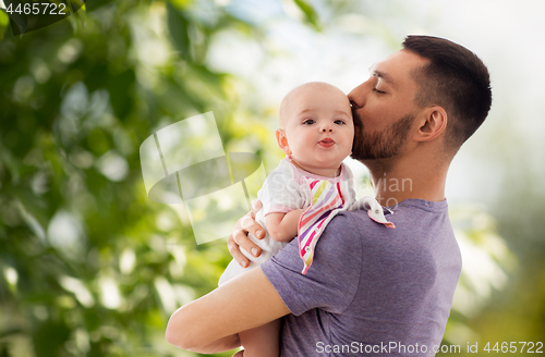 Image of father kissing little baby daughter