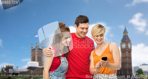 Image of friends with smartphone over houses of parliament