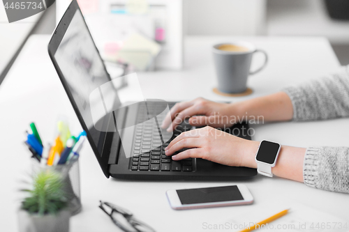 Image of web designer with laptop working on user interface