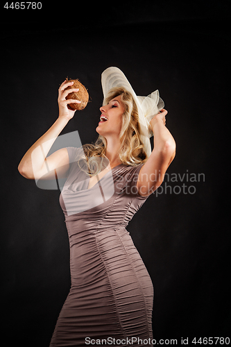 Image of Young woman with coconut in hand