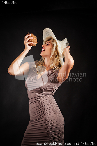 Image of Young woman with coconut in hand