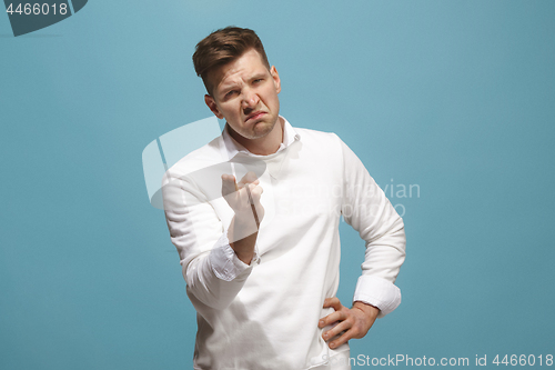 Image of The overbearing businessman point you and want you, half length closeup portrait on blue background.