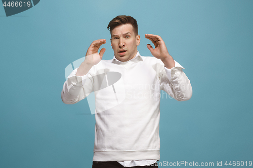 Image of Portrait of the scared man on blue