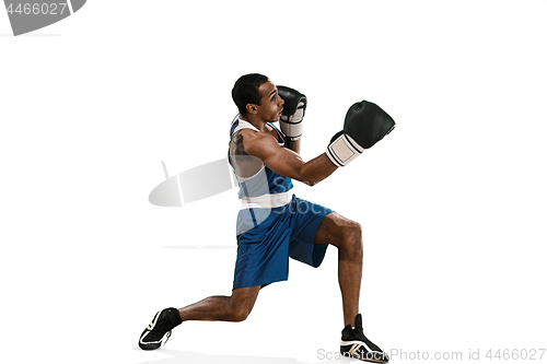 Image of Sporty man during boxing exercise making hit. Photo of boxer on white background