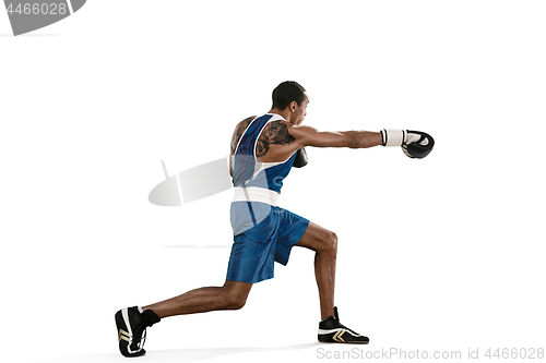 Image of Sporty man during boxing exercise making hit. Photo of boxer on white background