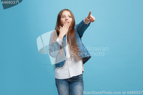 Image of Beautiful teen girl looking suprised isolated on pink