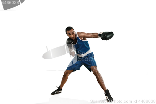 Image of Sporty man during boxing exercise making hit. Photo of boxer on white background