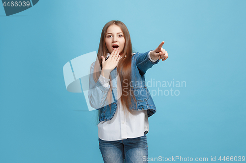 Image of Beautiful teen girl looking suprised isolated on pink