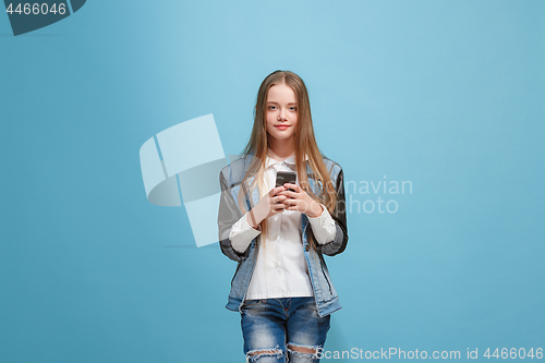 Image of Beautiful teen girl looking suprised isolated on blue
