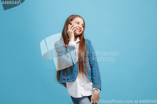 Image of Beautiful teen girl looking suprised isolated on blue