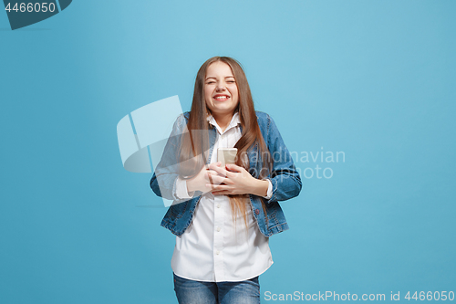 Image of Beautiful teen girl looking suprised isolated on blue
