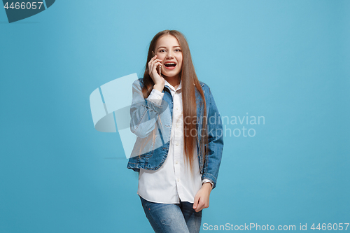 Image of Beautiful teen girl looking suprised isolated on blue