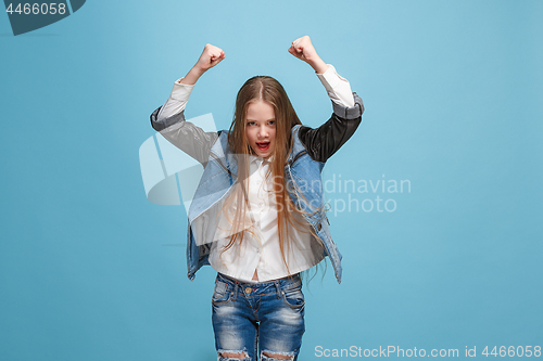 Image of Happy success teen girl celebrating being a winner. Dynamic energetic image of female model