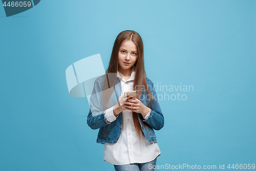 Image of Beautiful teen girl looking suprised isolated on blue
