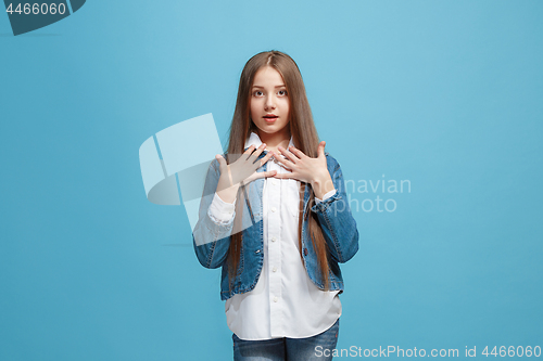 Image of Beautiful teen girl looking suprised isolated on blue