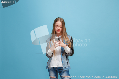 Image of Beautiful teen girl looking suprised isolated on blue