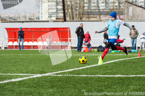 Image of Boy kicking soccer ball