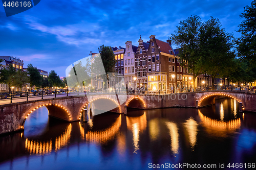 Image of Amterdam canal, bridge and medieval houses in the evening