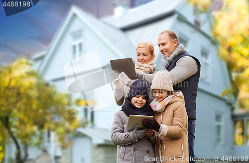 Image of family with tablet pc over living house in autumn