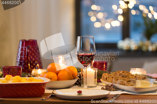 Image of glass of red wine and food on christmas table