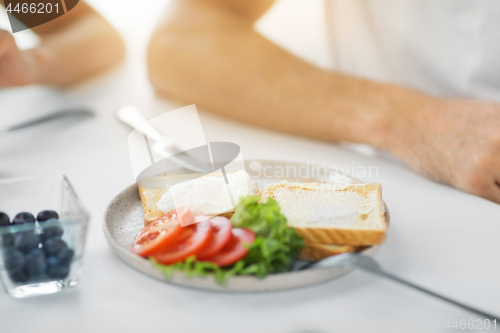 Image of toasts with poached egg and vegetables on plate