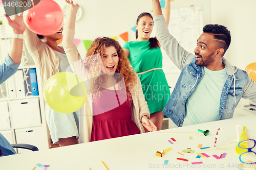 Image of happy team having fun at office party