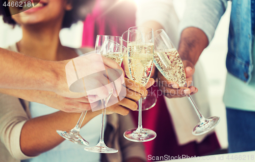 Image of friends clinking glasses of champagne at party