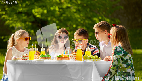 Image of happy kids on birthday party at summer garden