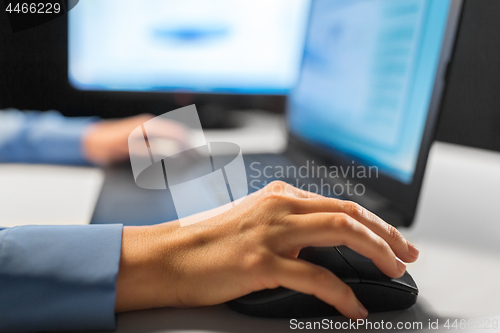 Image of close up of female hand using computer mouse