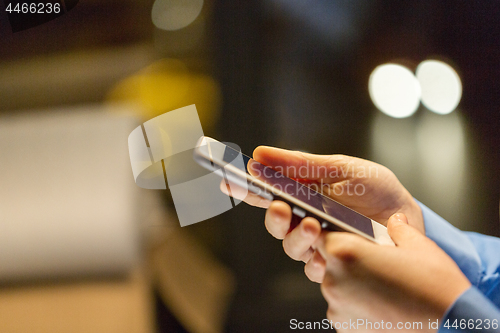 Image of close up of businesswoman hands with smartphone