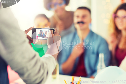 Image of friends or coworkers photographing at office party