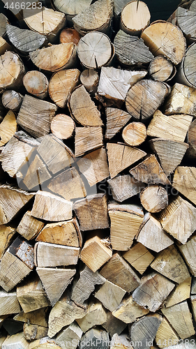 Image of Firewood pile stacked chopped wood trunks