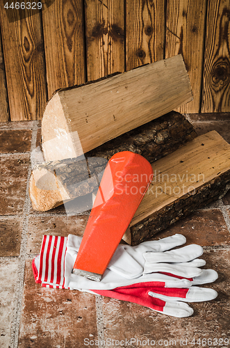 Image of Saw, mittens and firewood, close-up