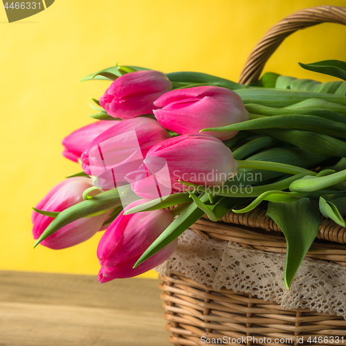 Image of Beautiful bouquet of pink tulips in a wicker basket