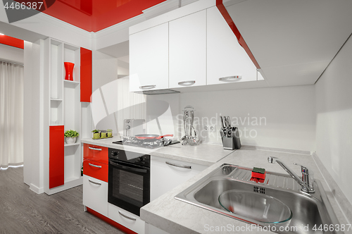 Image of Modern red and white kitchen interior