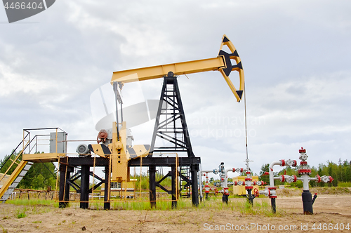 Image of Pump jack and oil well.