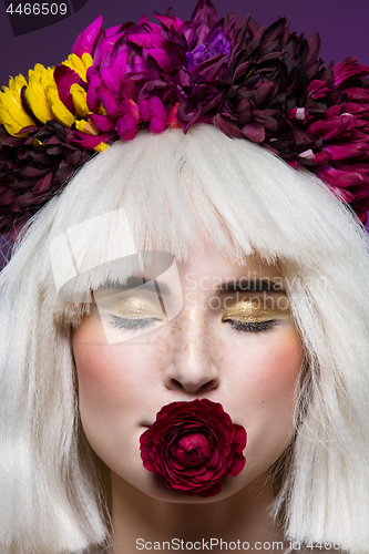 Image of Beautiful girl with rose in mouth