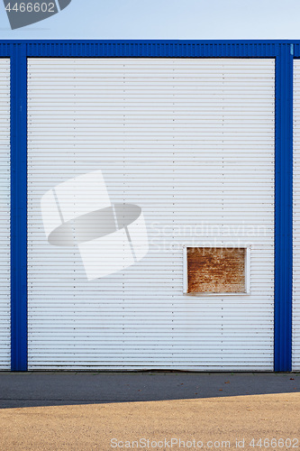 Image of White Industrial warehouse wall in blue frame.